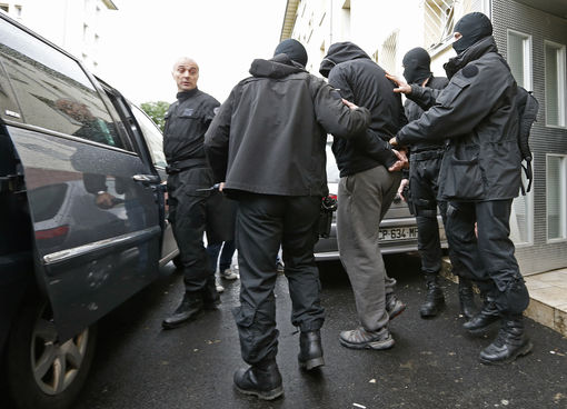 French special Police forces escort a suspect from a residential building in the Meinau suburb of Strasbourg, May 13. 2014. Interior Security (DGSI) services reinforced by special RAID and GIPN intervention forces conducted early morning raids to arrest six alleged djihadists who travelled back from Syria, French Interior minister announced. REUTERS/Vincent Kessler (FRANCE - Tags: CRIME LAW) EDITORS NOTE: FRENCH REQUIRES THAT FACES OF ENFORCEMENT OFFICERS ARE MASKED IN PUBLICATIONS WITHIN FRANCE REUTERS - RTR3OVZF